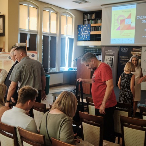 Powiększ obraz: grupa ludzi na sali, gości inauguracji